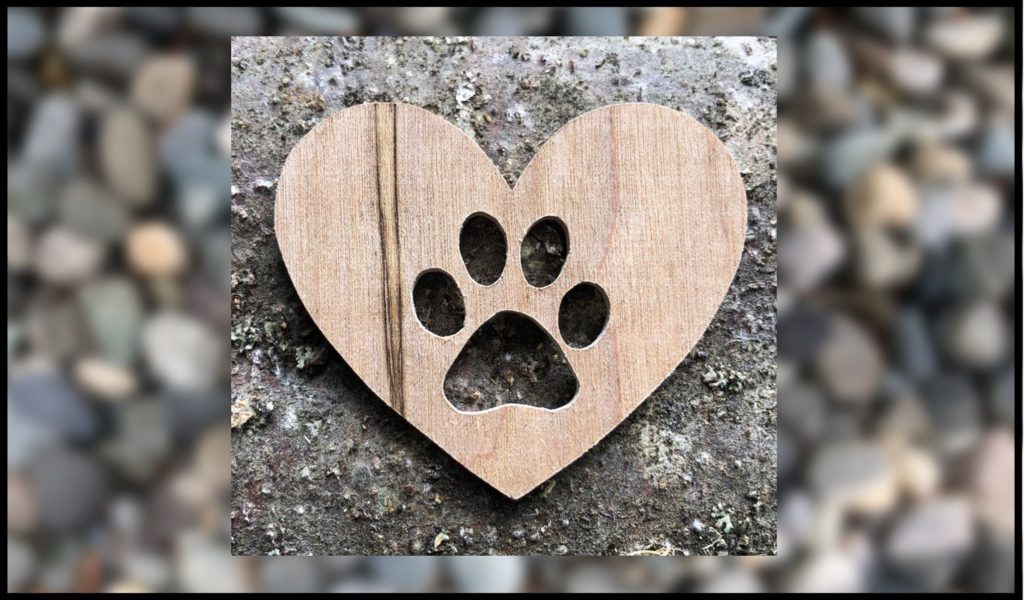 paw in heart cut out of wood
